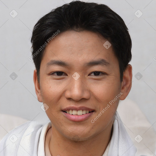 Joyful asian young-adult male with short  brown hair and brown eyes