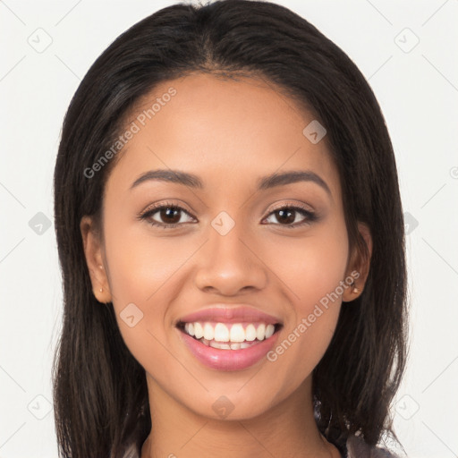 Joyful latino young-adult female with long  brown hair and brown eyes