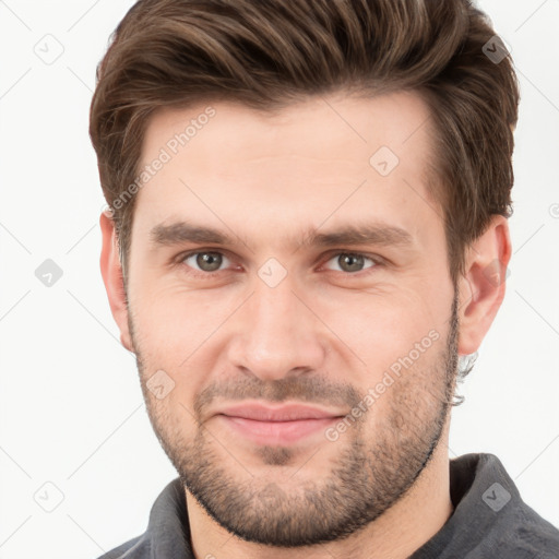 Joyful white young-adult male with short  brown hair and grey eyes