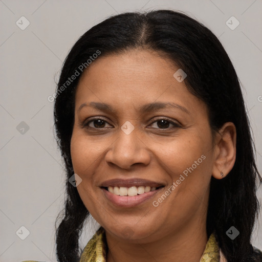 Joyful latino adult female with long  brown hair and brown eyes