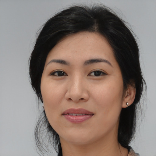 Joyful asian young-adult female with medium  black hair and brown eyes