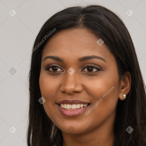 Joyful black young-adult female with long  brown hair and brown eyes