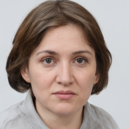 Joyful white adult female with medium  brown hair and brown eyes