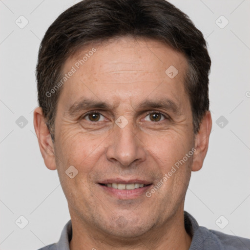 Joyful white adult male with short  brown hair and brown eyes