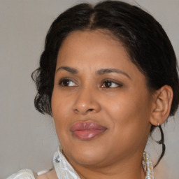 Joyful black young-adult female with medium  brown hair and brown eyes