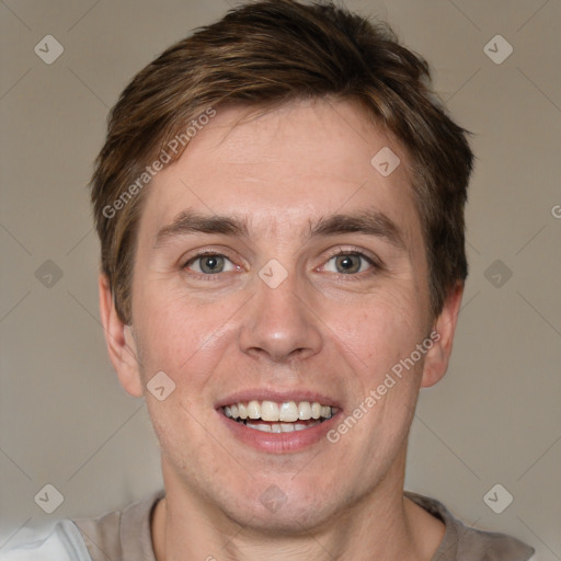 Joyful white adult male with short  brown hair and grey eyes