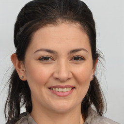 Joyful white young-adult female with medium  brown hair and brown eyes