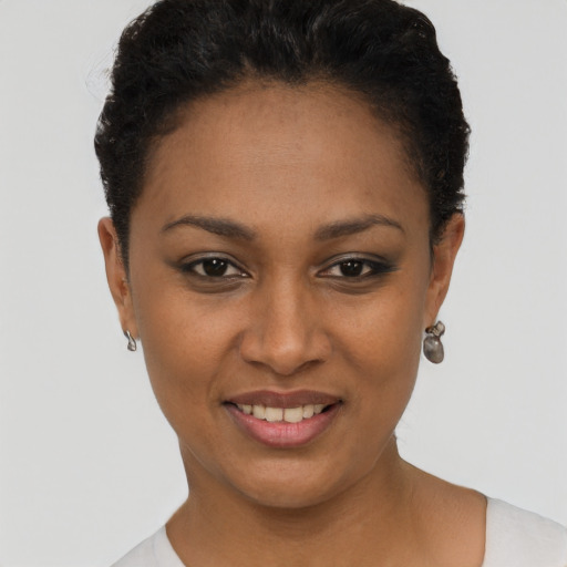 Joyful black young-adult female with short  black hair and brown eyes