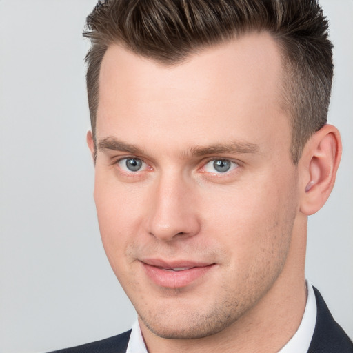 Joyful white young-adult male with short  brown hair and brown eyes