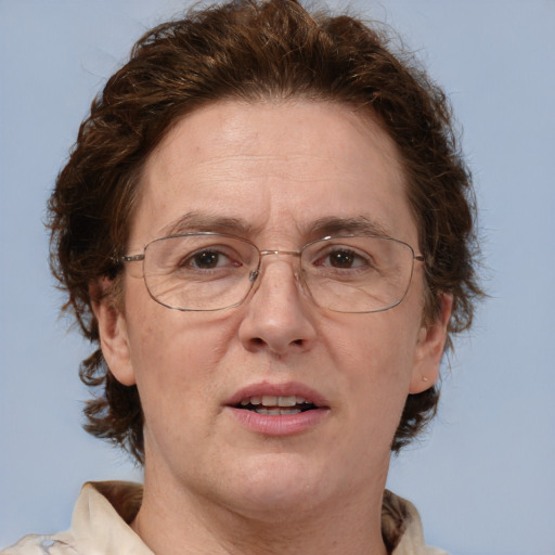 Joyful white middle-aged female with short  brown hair and blue eyes