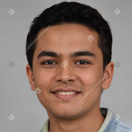 Joyful latino young-adult male with short  brown hair and brown eyes