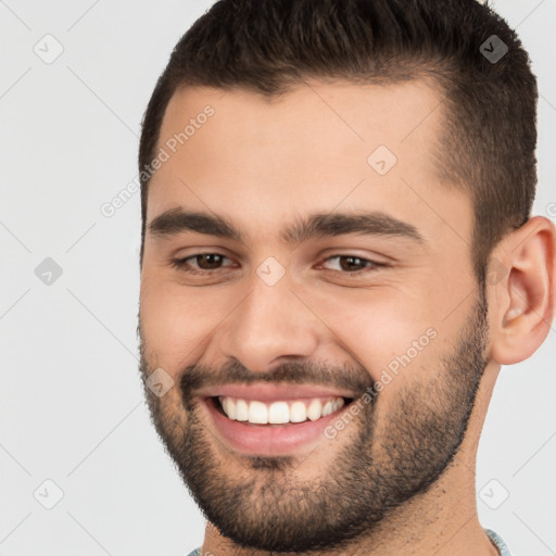 Joyful white young-adult male with short  brown hair and brown eyes