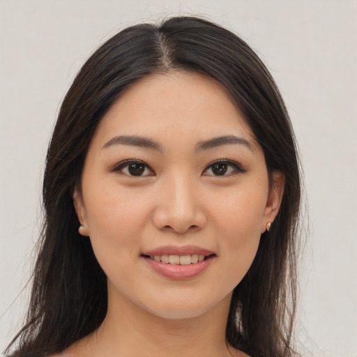 Joyful asian young-adult female with long  brown hair and brown eyes