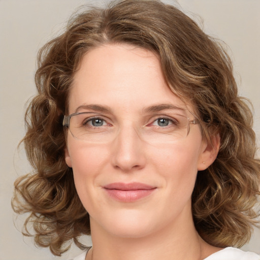 Joyful white young-adult female with medium  brown hair and green eyes