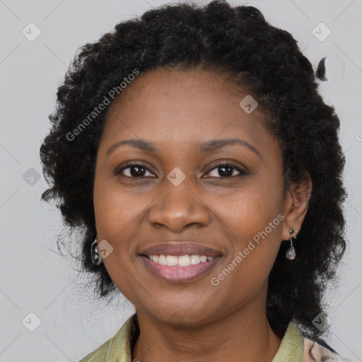 Joyful black young-adult female with long  brown hair and brown eyes