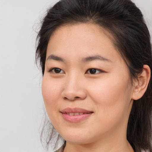 Joyful asian young-adult female with medium  brown hair and brown eyes