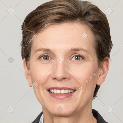 Joyful white adult female with short  brown hair and grey eyes