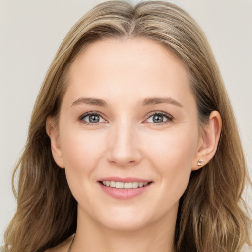 Joyful white young-adult female with long  brown hair and grey eyes