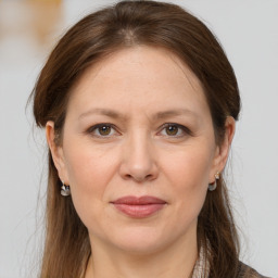 Joyful white adult female with medium  brown hair and brown eyes