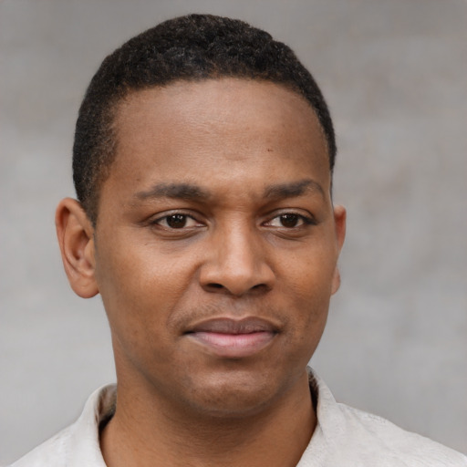 Joyful latino young-adult male with short  brown hair and brown eyes