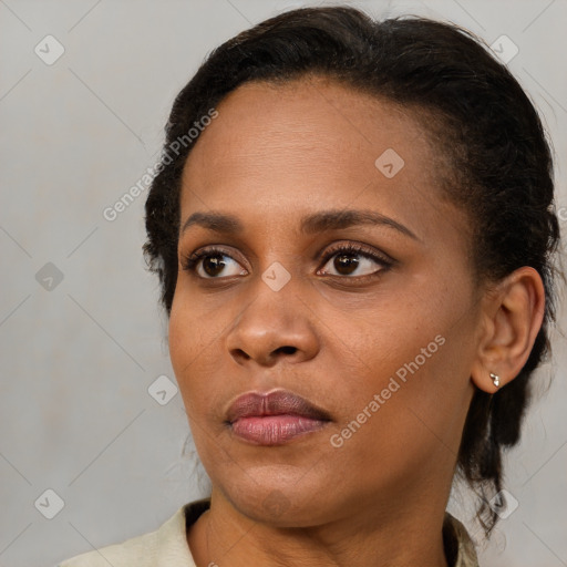 Neutral black young-adult female with medium  brown hair and brown eyes