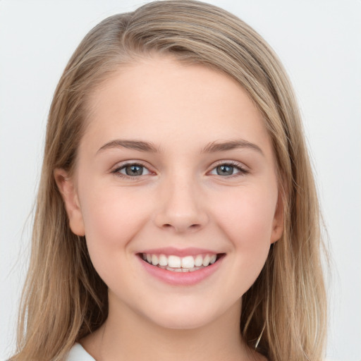 Joyful white young-adult female with long  brown hair and blue eyes