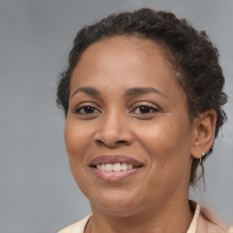 Joyful black adult female with medium  brown hair and brown eyes