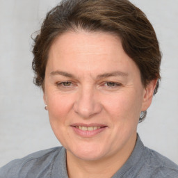 Joyful white adult female with medium  brown hair and blue eyes