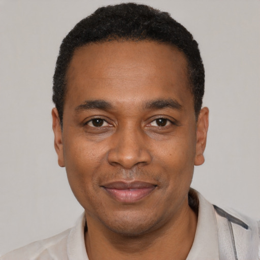 Joyful latino adult male with short  black hair and brown eyes