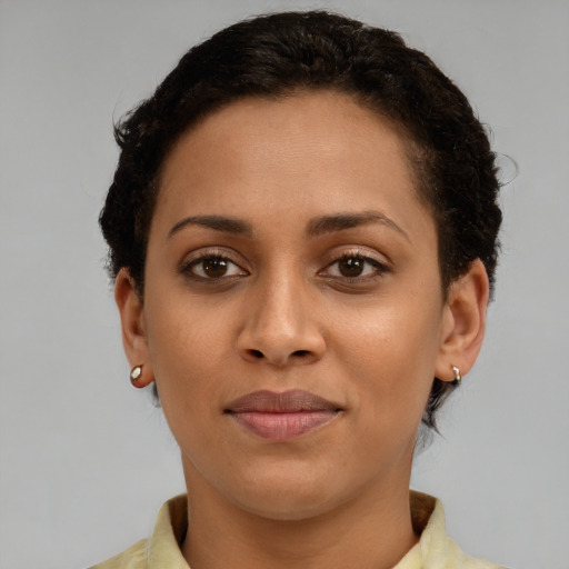 Joyful latino young-adult female with short  brown hair and brown eyes