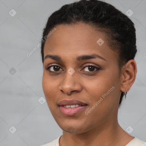 Joyful black young-adult female with short  brown hair and brown eyes