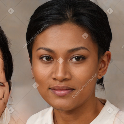 Joyful latino young-adult female with medium  brown hair and brown eyes