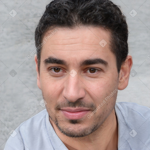 Joyful white young-adult male with short  black hair and brown eyes