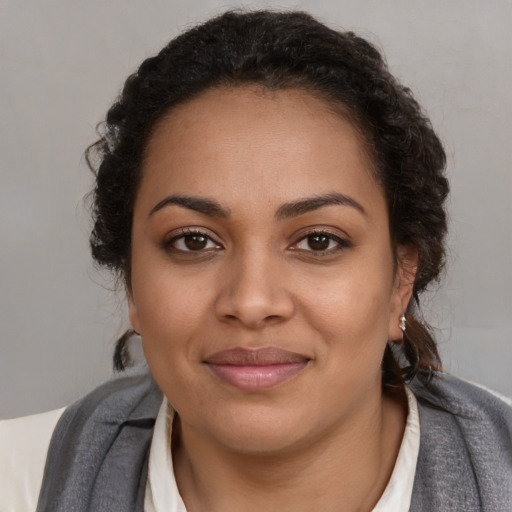 Joyful black young-adult female with medium  brown hair and brown eyes