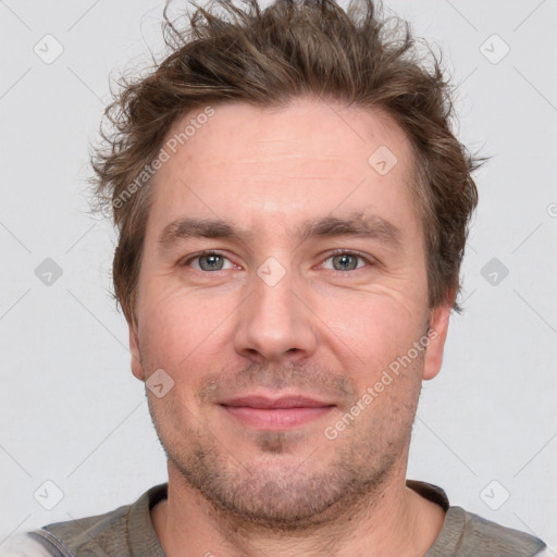 Joyful white adult male with short  brown hair and grey eyes