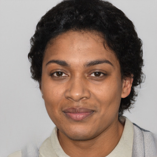 Joyful black adult female with short  black hair and brown eyes