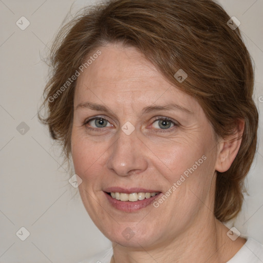 Joyful white adult female with medium  brown hair and grey eyes