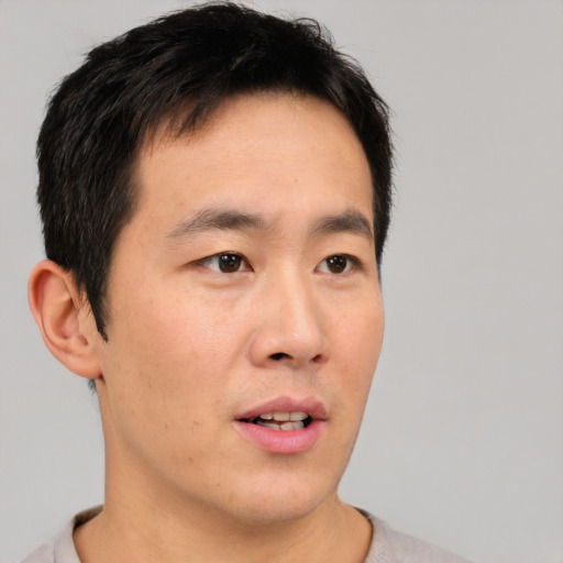 Neutral asian young-adult male with short  black hair and brown eyes
