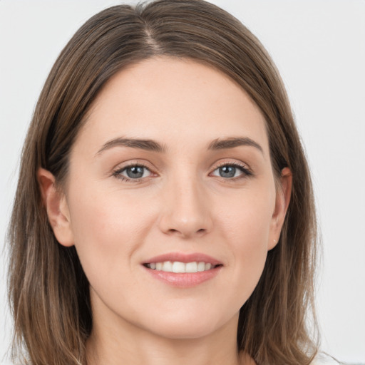 Joyful white young-adult female with long  brown hair and grey eyes