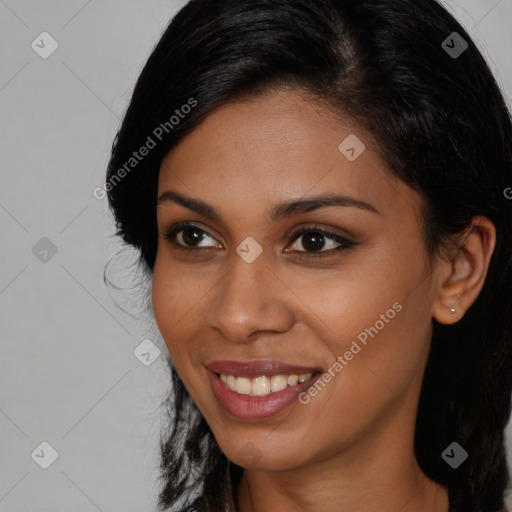 Joyful black young-adult female with long  brown hair and brown eyes