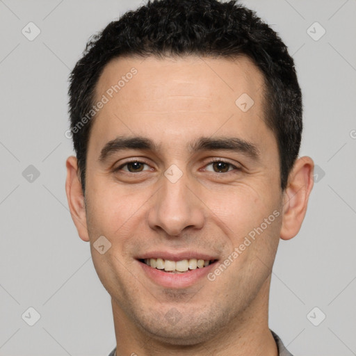 Joyful white young-adult male with short  black hair and brown eyes