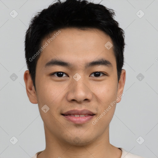 Joyful asian young-adult male with short  black hair and brown eyes