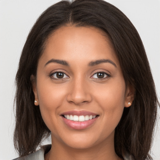 Joyful white young-adult female with long  brown hair and brown eyes