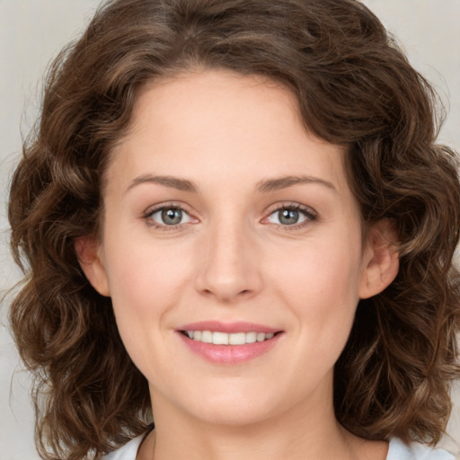 Joyful white young-adult female with medium  brown hair and green eyes