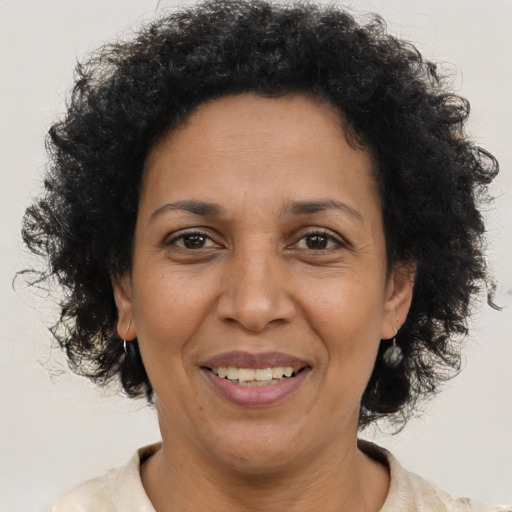 Joyful black adult female with short  brown hair and brown eyes