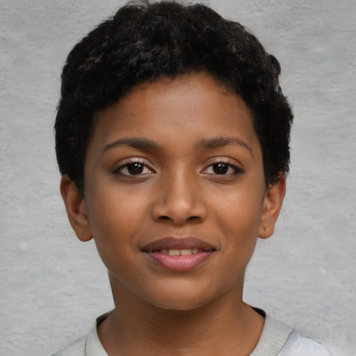 Joyful black child female with short  black hair and brown eyes