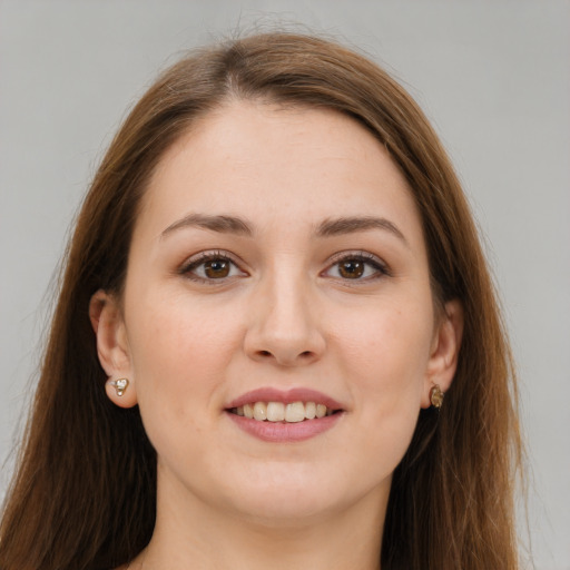 Joyful white young-adult female with long  brown hair and brown eyes