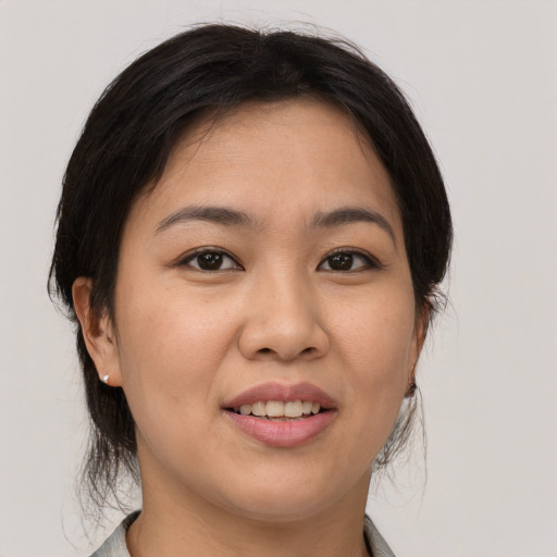 Joyful asian young-adult female with medium  brown hair and brown eyes