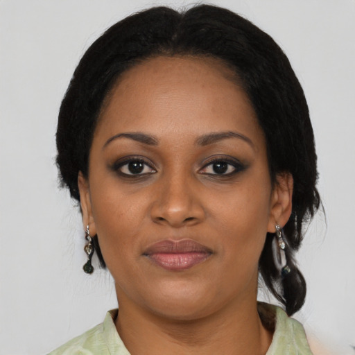 Joyful black young-adult female with medium  black hair and brown eyes