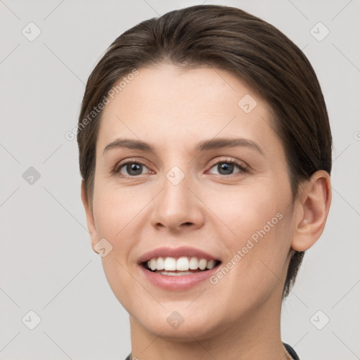 Joyful white young-adult female with short  brown hair and grey eyes